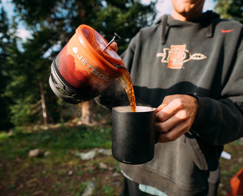 Pouring freshly brewed coffee from Jetboil MiniMo System