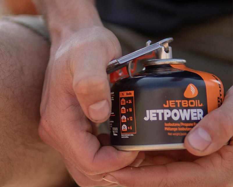 Holding Jetboil CrunchIt tool and JetPower Fuel