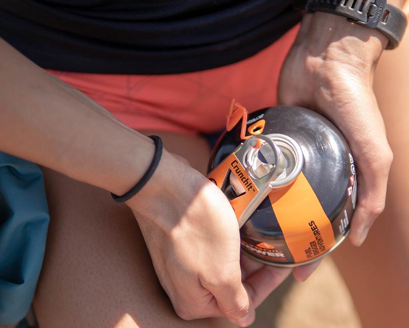 Holding Jetboil CrunchIt tool and JetPower Fuel