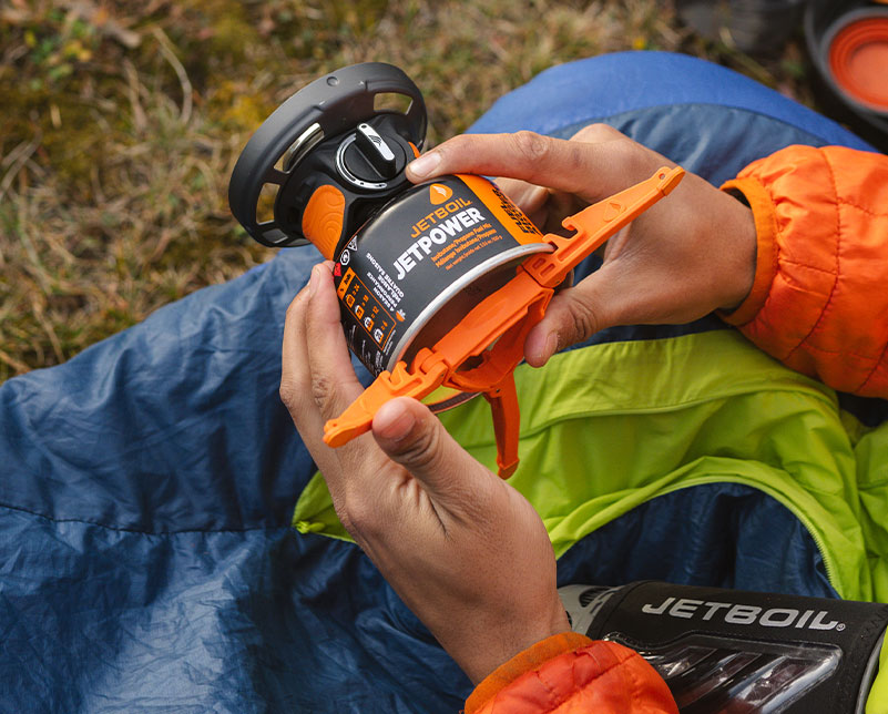 Holding Jetboil Flash 1.0L burner attached to fuel and fuel can stabilizer 2.0