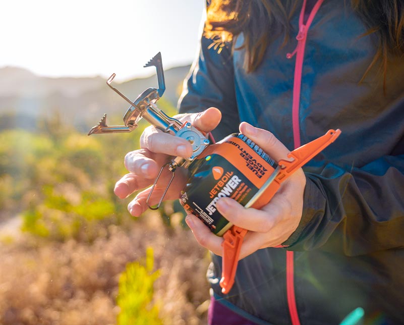 Holding Jetboil MightyMo and JetPower Fuel