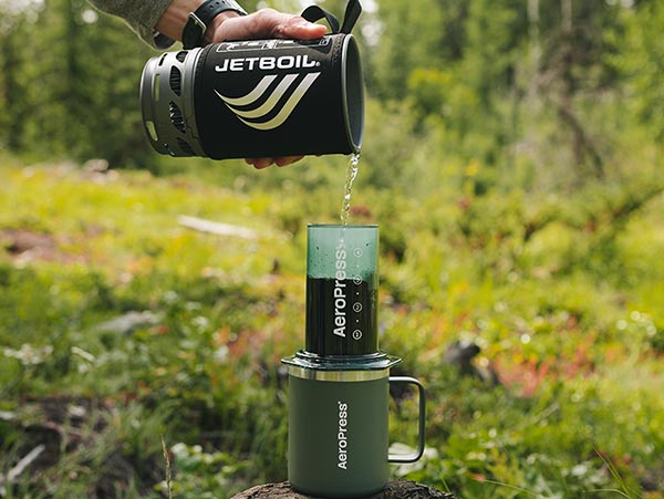 Pouring hot water from a Jetboil Flash 1.0L Into an AeroPress to make coffee