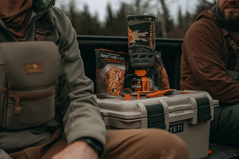 Hunters in back of truck with Jetboil Flash 1.0L Fast Boil System and dehydrated meals