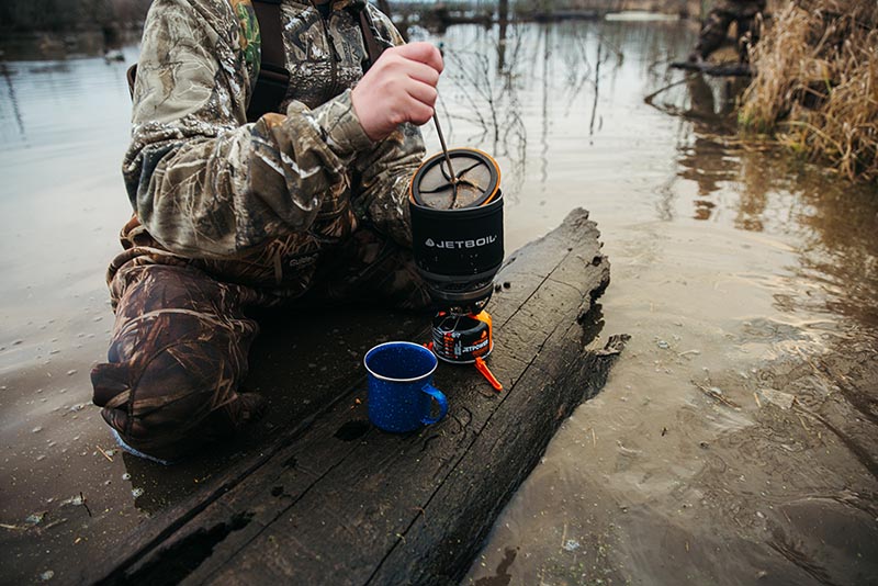 Using Jetboil silicone coffee press in a MiniMo in the middle of hunting in a stream