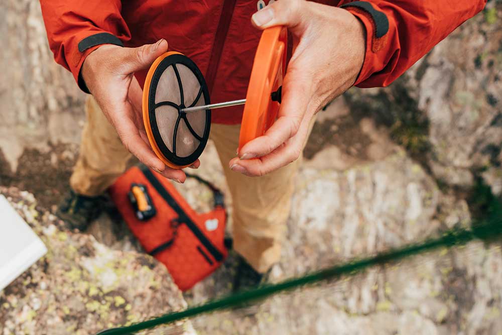 Holding the Jetboil silicone coffee press attached to MiniMo lid while outside