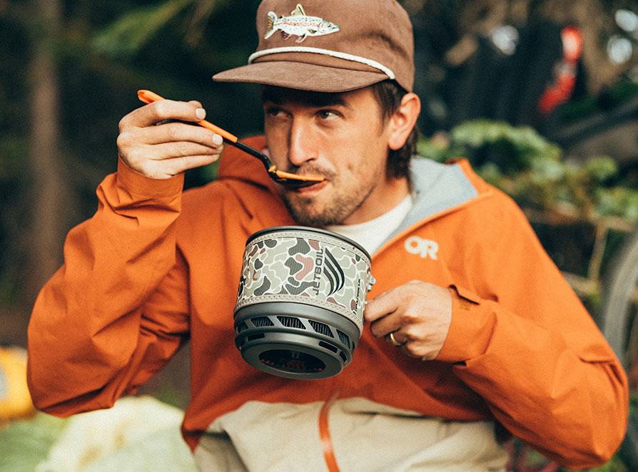 Man enjoying a cooked meal in the Jetboil TrailCook 1.2L Cooking System