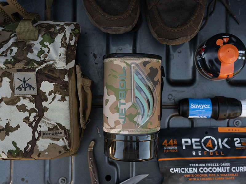 A Jetboil Flash on a tailgate with other hunting gear.