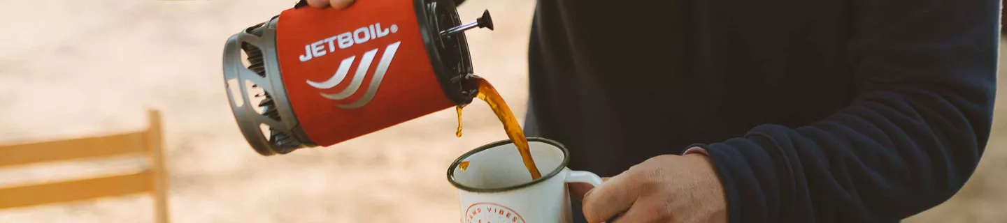 Pouring freshly made coffee from the Jetboil Flash Cooking System & Coffee Press