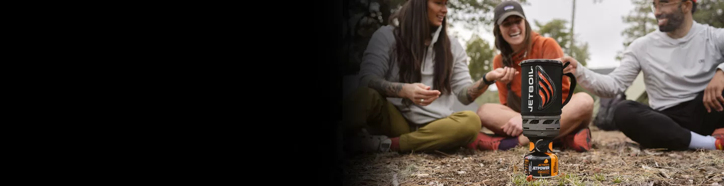 Friends gathered around a steaming Jetboil Flash 1.0L Cooking System