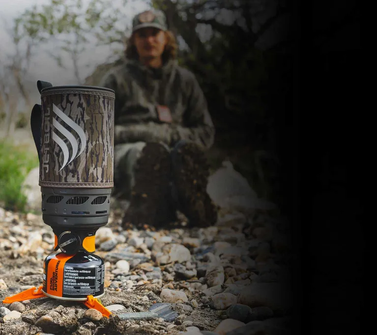 Two men gathered around a Jetboil Flash 1.0L Fast Boil System in Bottomland