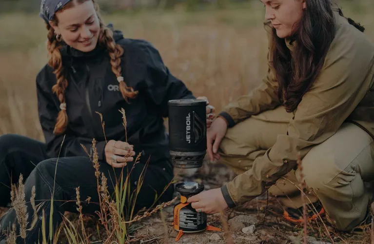 Lifting the Jetboil Flash 1.8L fast boil system onto heated burner to boil water