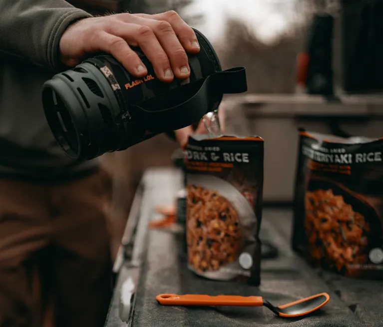 Pouring boiling water from Jetboil Flash 1.0L into freeze dried meal